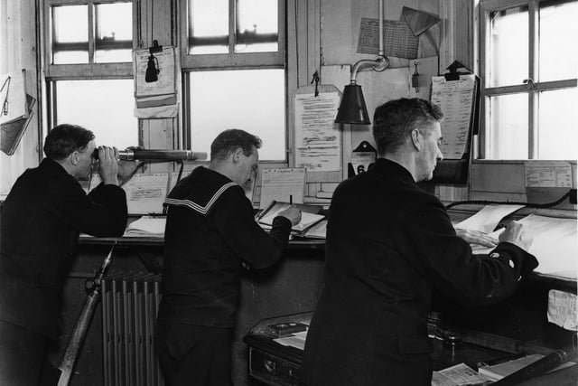 1940:  Sailors at the Central Signal station, Portsmouth, southern England, during WW II. One is using a telescope.  (Photo by Central Press/Getty Images)