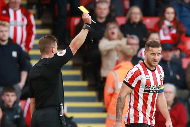 Billy Sharp of Sheffield United receives a yelliw card from referee Josh Smith: Lexy Ilsley / Sportimage