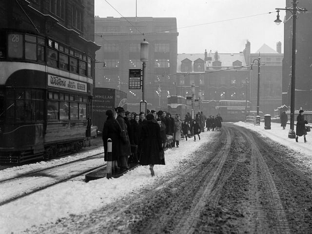 Snow and slush at a tram stop in Edinburgh - looking north down Lothian Road to the West End in February 1955.