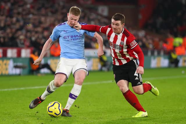Kevin De Bruyne of Manchester City battles for possession with John Fleck of Sheffield United  during the Premier League match between Sheffield United and Manchester City at Bramall Lane. (Photo by Catherine Ivill/Getty Images)