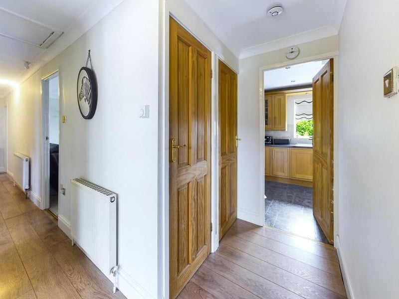 Inner Hallway - Wood effect laminate flooring, loft access with folding loft ladder, two fitted storage closets and two radiator panels.