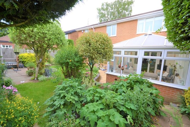 Rear garden - Wrought iron gates to either side of the property give access to a fully enclosed and private rear garden, having mature trees, shrubs and flowers frame various patio seating areas and well kept lawn, there is access back into the breakfast room and conservatory.