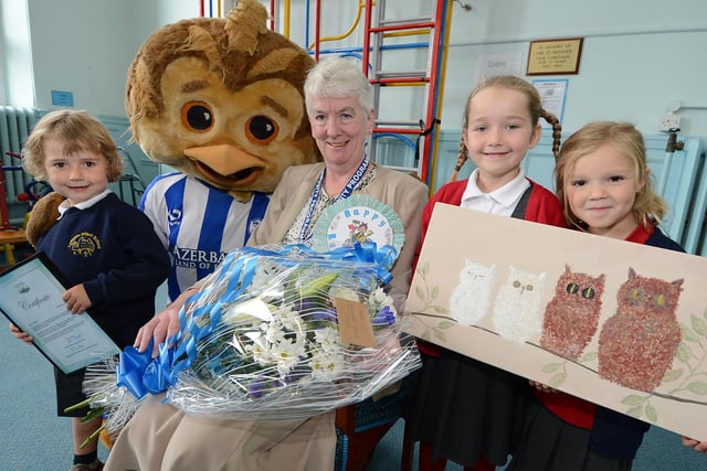 Sheffield Wednesday fan Anne Greatorex retired from her job as a cleaner at Lydgate Infants School in 2014 after 33 years. Our picture shows Anne with Wednesday mascot Ollie and pupils, from left, Albert Wales, aged four, Sophia Wales and Esme Sait-Bush, both aged six.