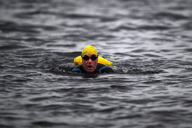 Open water swimming enthusiasts enjoy an early morning swim in Loch Lomond,Trossachs, Scotland. A new study from the UK Dementia Research Institute found that the blood of regular winter swimmers contains a "cold-shock" protein that wasn't found in that of people who did other cold-weather exercise on dry land.
