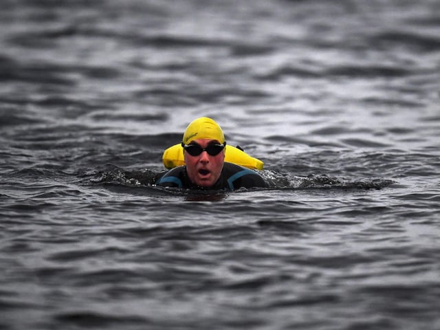 Open water swimming enthusiasts enjoy an early morning swim in Loch Lomond,Trossachs, Scotland. A new study from the UK Dementia Research Institute found that the blood of regular winter swimmers contains a "cold-shock" protein that wasn't found in that of people who did other cold-weather exercise on dry land.
