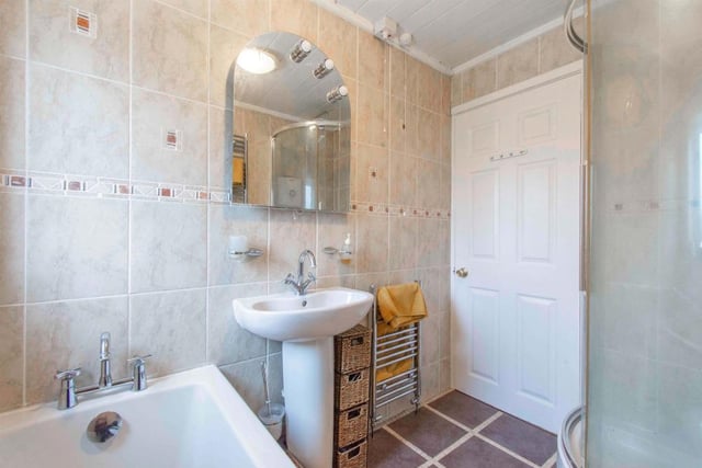 Family Bathroom - fitted with a four piece suite comprising of a low flush WC, a wash hand basin with mixer tap, a bath with mixer tap and a corner electric shower with tile surround. The bathroom has wall to floor tiling, two chrome heated towel rails and an extractor fan. With a rear facing opaque double glazed window.