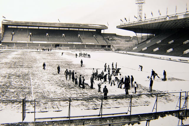 Volunteers clear snow off the pitch at Hillsborough on the morning of the FA Cup third round tie against Arsenal in January 1979. The tie spanned a marathon five games before the Gunners secured their passage through to the fourth round.