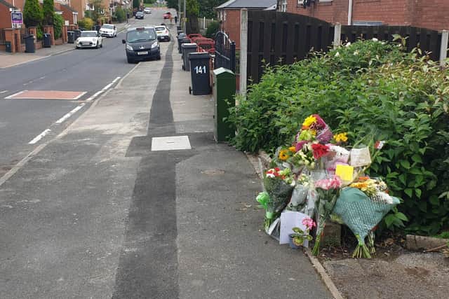 Flowers left at the scene of the murder on Windy House Lane. A 42-year-old man died at the scene after he was found with "critical injuries".