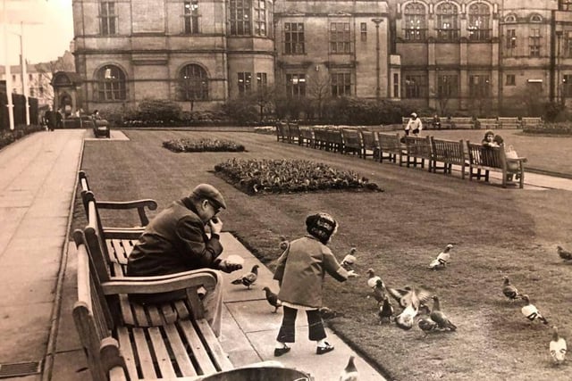 A little girl feeding the Peace Garden pigeons in May 1971