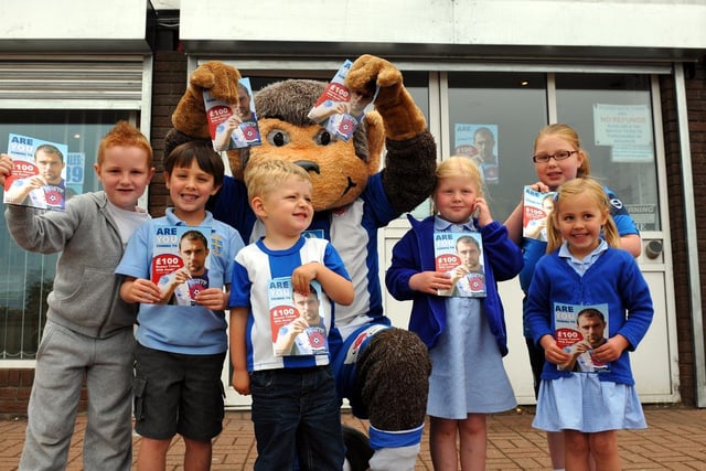 H'Angus joined young Hartlepool United supporters (left to right) Arron Leak, Thomas Loughlin, Leo Rooke, Libby Frostick, Heather Horsley and Hannah Loughlin when they collected season tickets in this picture. Picture by FRANK REID
