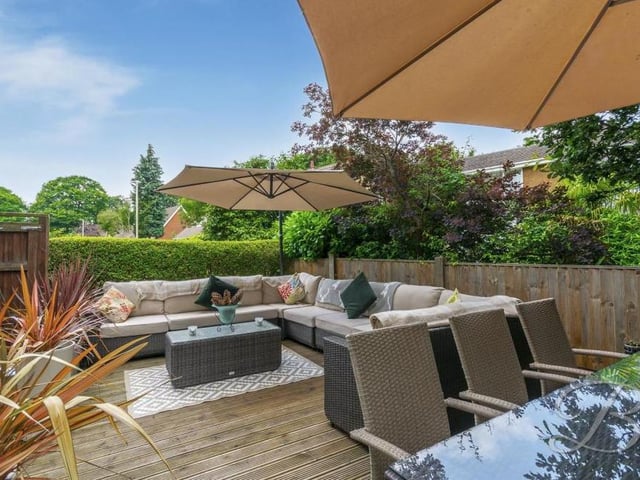 Moving outside now into the garden, and this spacious decked seating area is perfect for entertaining family and friends. A summer delight, no less.