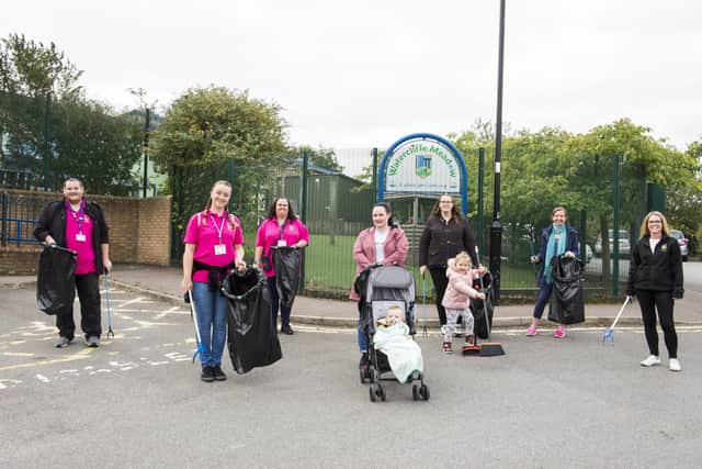 The group of volunteers from Watercliffe Meadow Primary litter picking outside the school