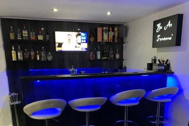 Ian Fenton's bar is a little upmarket - with blue LED lights and shelves filled with spirits.