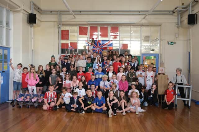 Pupils from Lound Infant and Junior School recreate a picture from the Queens coronation in 1953.