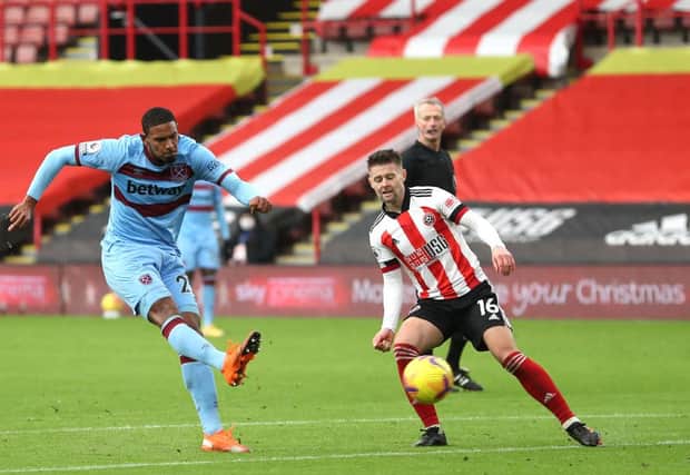 Sebastian Haller of West Ham United scores their side's goal whilst under pressure from Ollie Norwood of Sheffield United during the Premier League match between Sheffield United and West Ham United at Bramall Lane  (Photo by Catherine Ivill/Getty Images)