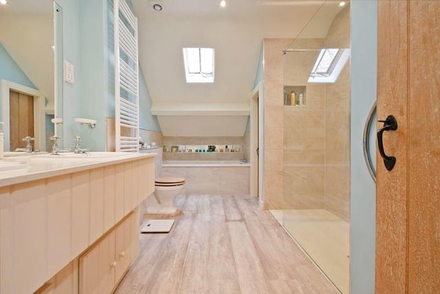 The master en-suite bath and shower room are light and bright, typical of this charming family home.