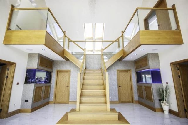 A beautiful feature of an oak dual-return staircase leads to the first floor