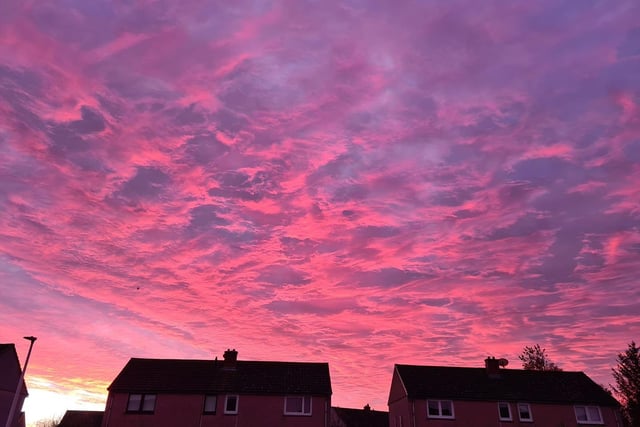 Penicuik's clouds were ablaze with dramatic pinks and blues amidst household rooftops.