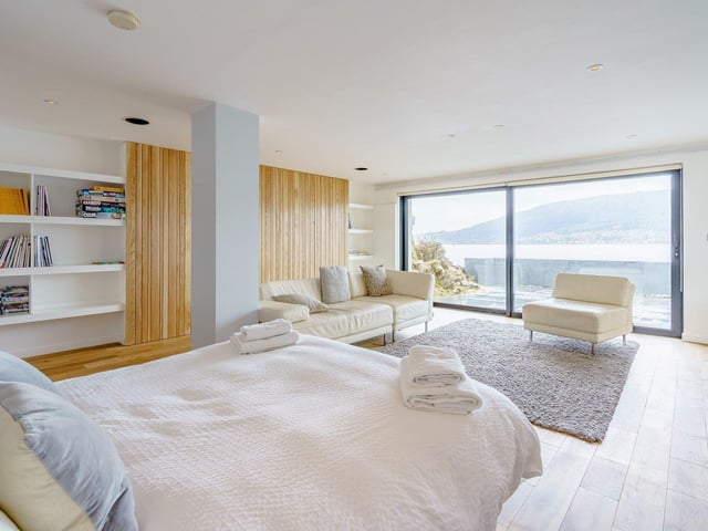 The master bedroom has a balcony in which to enjoy the coastal setting.