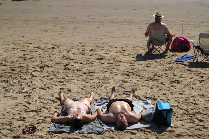 Sunbathers soaked up the heat down on the sands.