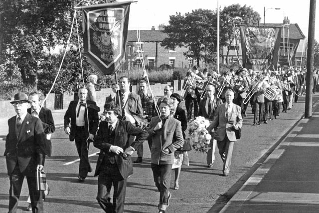 Boldon Colliery miners with their band and banners marching through the village before setting off by bus for the Durham Miners Gala. Remember this from 1980?