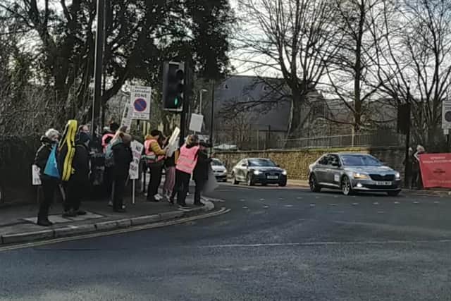 Passing motorists honked their horns as teachers waved banners and chanted over a megaphone.