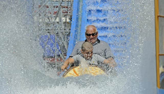 Maciej Ciarach and his grandson Alan (10) enjoy the new log flume. Picture Ian Hargreaves (180720-2)