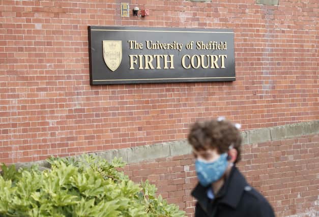 A man, wearing a face covering, walks past The University of Sheffield's Firth Court, after the university switched to online learning to protect the health of students and staff. Photo: Danny Lawson/PA Wire