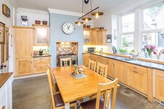 The dining kitchen is well-appointed with an integrated fridge, freezer and dishwasher, as well as a double oven and a six-ring hob.