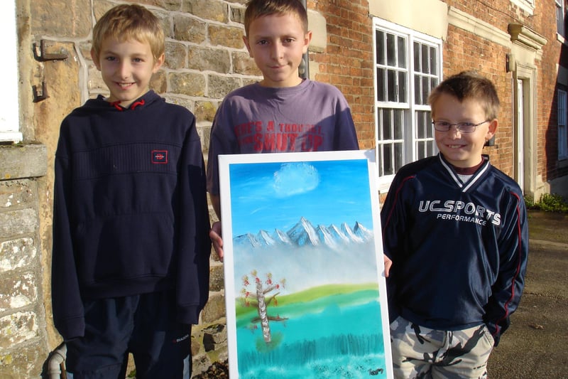 Pictured some of the members of the 3rd Buxton Harpur Hill Cub Pack with some of the art they created in 2006