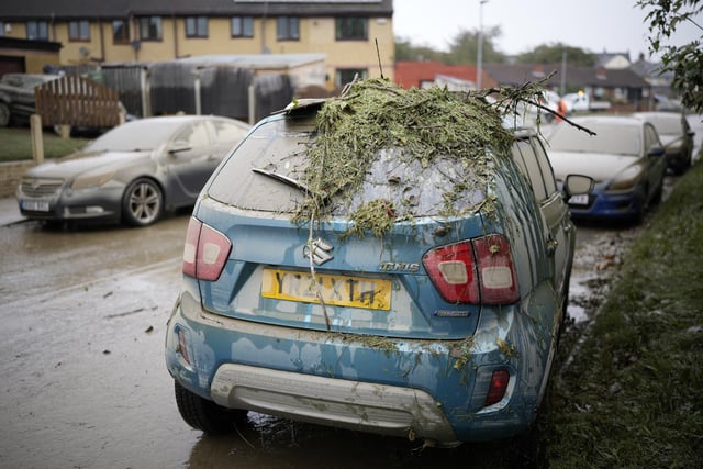 ROTHERHAM, UNITED KINGDOM - OCTOBER 23: Damage is seen on a residents car as flood waters recede in the village of Catcliffe after Storm Babet flooded home, business and roads on October 23, 2023 in Rotherham, United Kingdom. The UK Environment Agency has warned that flooding could last for days in the wake of Storm Babet with 116 flood warnings remaining in place across England. (Photo by Christopher Furlong/Getty Images)