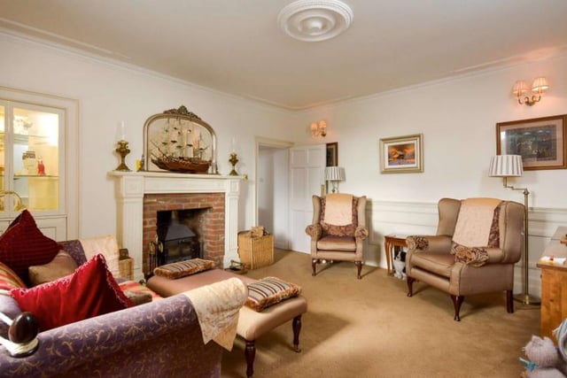 The family room enjoys a working fireplace and south facing double glazed windows with working shutters. From the family room, you can access the kitchen