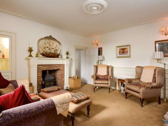 The family room enjoys a working fireplace and south facing double glazed windows with working shutters. From the family room, you can access the kitchen