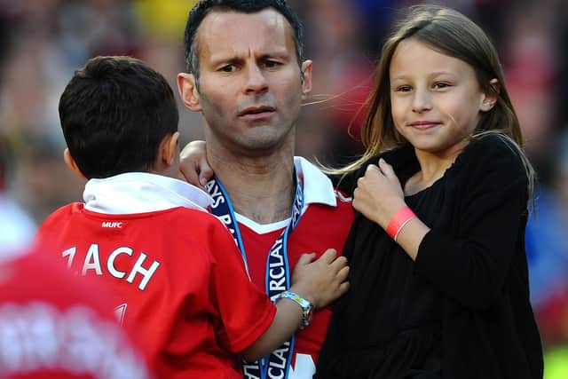 Manchester United's Welsh midfielder Ryan Giggs celebrates with his children (Zach and Libby) after his team were presented with the English Premier League trophy after their match against Blackpool at Old Trafford in Manchester, north west England, on May 22, 2011: PAUL ELLIS/AFP via Getty Images