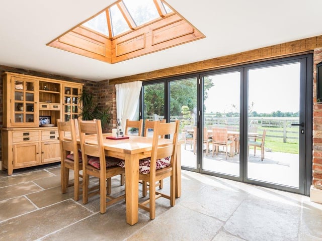 The open plan kitchen diner offers plenty of room for both family meals and entertaining guests, with the dining table overlooking the gardens.