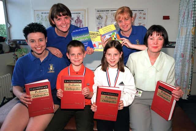Kimberley and Garreth Womack presented a cheque for new books at the Sheffield Childrens Hospital dept of Physiotherapy afdter completing the Star Walk in 1999.... l-r...Claire Wagstaff,  Sarah Wright, Garreth Womack,  Kimberley Womack, Sarah Huxford, Anglea Karck.