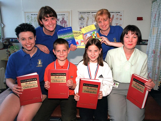 Kimberley and Garreth Womack presented a cheque for new books at the Sheffield Childrens Hospital dept of Physiotherapy afdter completing the Star Walk in 1999.... l-r...Claire Wagstaff, Sarah Wright, Garreth Womack, Kimberley Womack, Sarah Huxford, Anglea Karck.