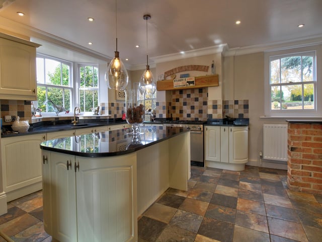Having fitted wall and base level units, central island, solid granite worktops with inset sink and drainer. Integrated fridge, freezer, dishwasher, microwave and Rangemaster oven and hob.