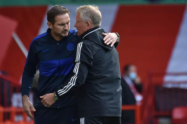 Frank Lampard (L) and Sheffield United's English manager Chris Wilder (R) chat on the touchline after the English Premier League football match between Sheffield United and Chelsea at Bramall Lane.  (Photo by Rui Vieira / POOL / AFP)