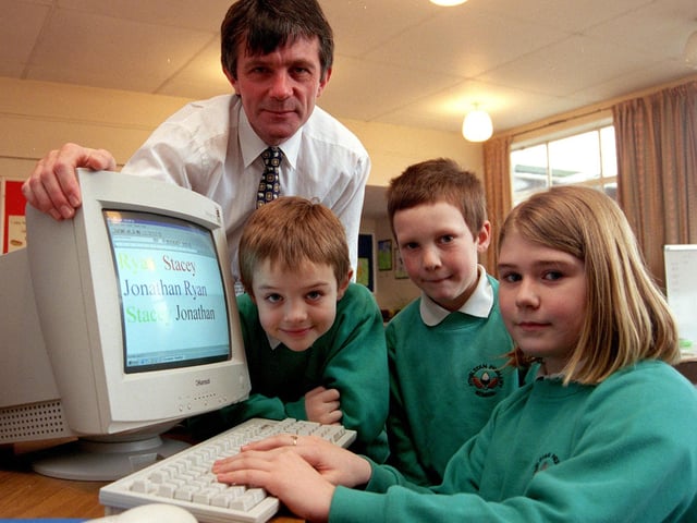 Athelstan Primary School headteacher Tony Woodward looks on as pupils Sally Yeomans (9),Ryan Harrison (8) and Jonathan Bloodworth (7) try out their new computer won in a competition organised by ASDA in 1999