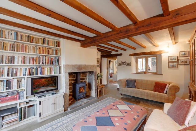 The cosy snug has exposed rustic beams and a log burning stove.