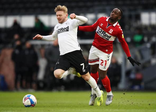 Kamil Jozwiak of Derby County is challenged by Neeskens Kebano of Middlesbrough.