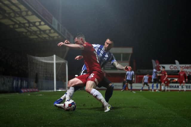 Sheffield Wednesday's Jack Hunt (right) and Cheltenham Town's Will Ferry battle for the ball during the Sky Bet League One match at the Completely-Suzuki Stadium, Cheltenham. Picture date: Wednesday March 29, 2023. PA Photo. See PA story SOCCER Cheltenham. Photo credit should read: Simon Marper/PA Wire.RESTRICTIONS: EDITORIAL USE ONLY No use with unauthorised audio, video, data, fixture lists, club/league logos or "live" services. Online in-match use limited to 120 images, no video emulation. No use in betting, games or single club/league/player publications.