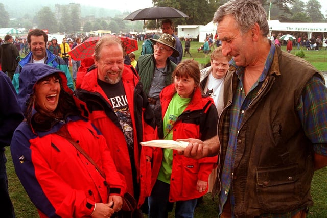 Pictured at the 1998 Chatsworth Country Fair. Seen is Peter Smith from The  Wirrall who was making Gypsy Clothes Pegs and and tent pegs, with visitors to the fair.