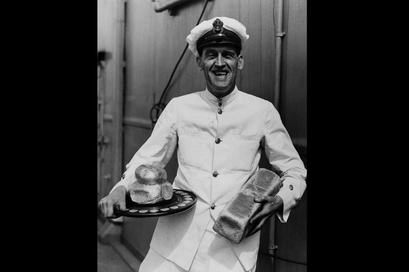 16th April 1939:  Chief petty officer cook Raw King holding a silver loaf award, aboard the new aircraft carrier 'Ark Royal'. He has won the Challenge Silver Loaf making him the fleet's champion baker.  (Photo by Fox Photos/Getty Images)