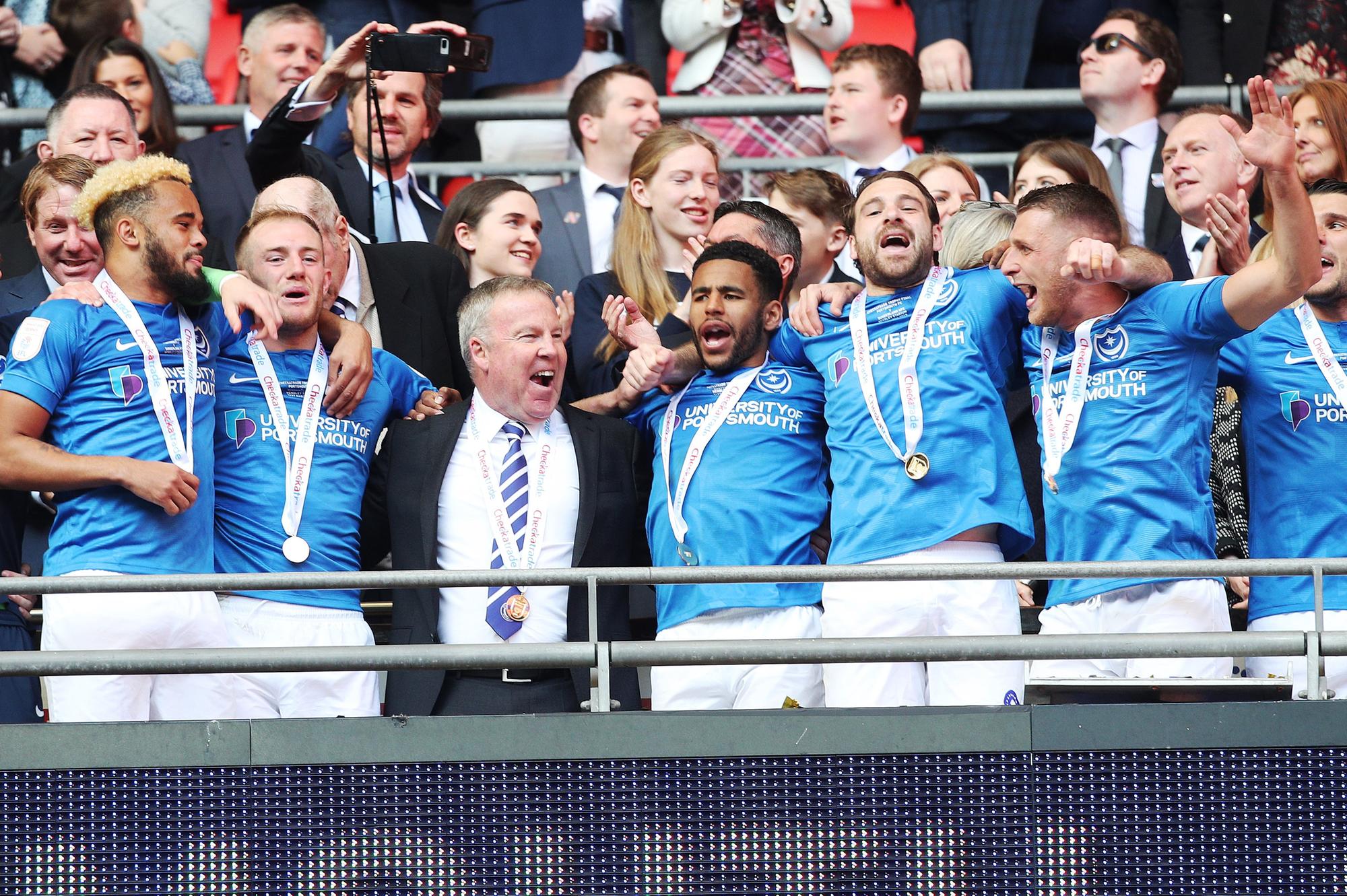 Kenny Jackett, centre left, celebrates Pompey's Checkatrade Trophy triumph with his players at Wembley. Picture: Joe Pepler