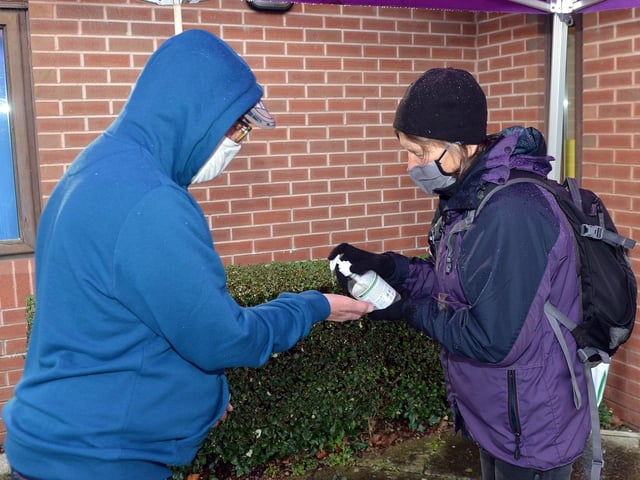 Volunteer Caroline Poland welcoming people coming to a vaccination centre at the Mathews Practice, Sheffield back in January. Many hundreds of Sheffielders have given their time to work alongside NHS staff throughout the pandemic to ensure that Sheffielders can safely get the Covid tests and vaccines they need.