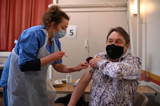 Nurse Sally Griffiths prepares to administer an injection of AstraZeneca/Oxford Covid-19 vaccine to a patient at the vaccination centre set up at St Columba's church in Sheffield. Photo by OLI SCARFF/AFP via Getty Images.