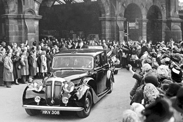 The crowds cheer Prime Minister Sir Winston Churchill as he leaves Sheffield Midland Station on a visit to Sheffield on April 16, 1951