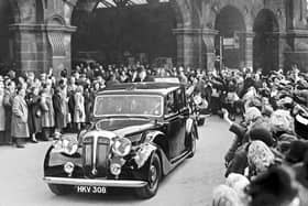 The crowds cheer Prime Minister Sir Winston Churchill as he leaves Sheffield Midland Station on a visit to Sheffield on April 16, 1951